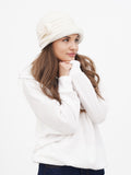 Full-length side view of woman with hands in hoodie pockets, wearing wool cloche hat