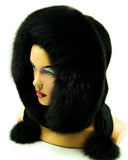 Black mink fur hood worn by woman, three-quarter view showing depth of polar fox trim around face
