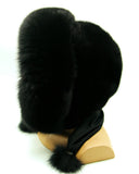 Side profile of black mink fur hood scarf wrap on mannequin showing scarf length and fox pompons