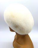 Luxury white mink beret for women three-quarter right view showing natural fur texture and beret shape
