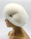 Luxury white mink gathered beret three-quarter right view showing tuck construction and natural fur sheen