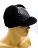 Man wearing black mink leather ushanka bill cap earflaps up