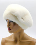 White mink beret with gathered tucks right profile view showing fur texture depth and constructed folds