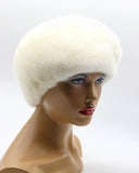 White mink beret gathered tucks three-quarter left view showing ridged surface texture and dome crown