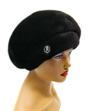 Women's black mink fur beret plain silhouette front three-quarter view showing dense natural mink texture and rounded crown