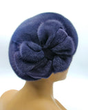 Women's mink fur beret with applique flower in graphite blue-grey, front view showing dense fur texture and large flower detail