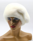 Women's white gathered mink fur beret front view showing pleated tuck pattern across crown surface