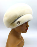 Women's white mink fur beret side profile view showing luminous white fur and rounded crown silhouette